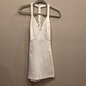 Cream colored dress, sleeveless.